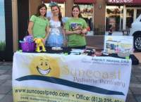 Suncoast Pediatric Dentistry table with the Tooth Fairy